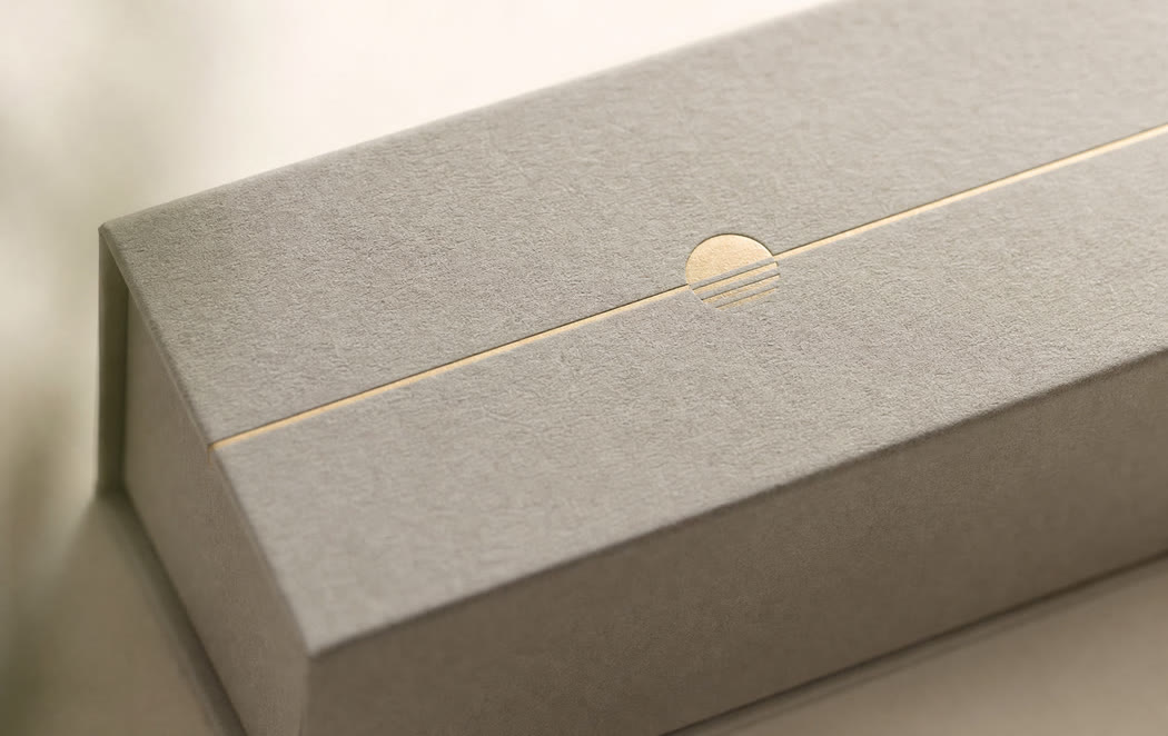 Macro detail of a foil-stamped logo on an eyewear case